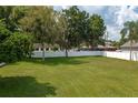 Large side yard with grassy area and white fence at 815 E Church St, Bartow, FL 33830