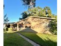 Side view of the house highlighting a large window and grassy area at 3022 21St Nw St, Winter Haven, FL 33881