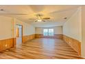 Bright living room with wood-look floors and ceiling fan at 408 Garrett Ridge Ct, Winter Haven, FL 33880