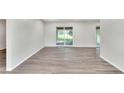 Spacious living room featuring wood-look floors and access to a backyard patio at 905 14Th Ne St, Winter Haven, FL 33881