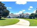 Two-story home with red door and circular driveway at 2418 Berkshire Dr, Winter Haven, FL 33884