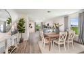 Bright dining area with farmhouse table and view to kitchen at 1021 Ambleside Dr, Haines City, FL 33844