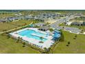 Aerial view of a community pool with a spacious deck and surrounding homes at 2363 Selenia St, Lake Alfred, FL 33850