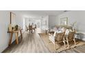 Bright and airy living room with hardwood floors and neutral decor at 2211 Majestic Span Ave, Eagle Lake, FL 33839