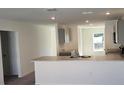 Kitchen features gray cabinets, granite countertops, and breakfast bar at 1412 Swan Ct, Poinciana, FL 34759