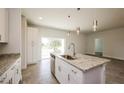 Kitchen island with granite countertops, stainless steel sink, and pendant lighting at 802 Fraser Dr, Poinciana, FL 34759