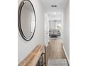 Bright hallway with wood-look floors, console table, and mirror at 1699 Nebraska Loop, Sumterville, FL 33585