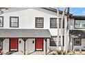 Two-story building with red doors and palm trees at 5675 Charleston St # 58, Orlando, FL 32807