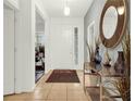 Bright and spacious entryway with tile flooring and elegant console table at 5240 Oakbourne Ave, Davenport, FL 33837
