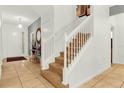Elegant staircase with white railings and carpeted steps at 5240 Oakbourne Ave, Davenport, FL 33837
