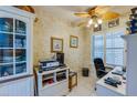 Home office with desk, chair, printer, and built-in shelving at 4670 Links Village Dr # D506, Ponce Inlet, FL 32127