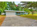 Blue house with American flag and spacious driveway at 6269 Se 125Th Pl, Belleview, FL 34420