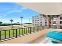 Balcony view of the ocean, palm trees, and beachfront property at 3370 Ocean Shore Blvd # 203B, Ormond Beach, FL 32176
