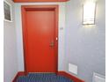 Condo entry with red door and blue carpet at 231 Riverside Dr # 2409-1, Holly Hill, FL 32117