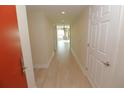 Light condo hallway with wood-look floors at 231 Riverside Dr # 2409-1, Holly Hill, FL 32117