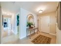 Bright and spacious condo entryway with tile flooring and a decorative mirror at 3801 S Atlantic Ave # 303, Daytona Beach Shores, FL 32118