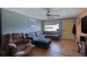 Living room with sectional sofa, ottoman, and view of front yard at 147 Longwood Dr, Ormond Beach, FL 32176