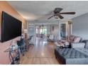 Living room with sectional sofa, large TV, and access to dining area at 147 Longwood Dr, Ormond Beach, FL 32176