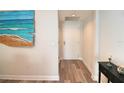 Condo hallway with light walls and wood-look floors at 231 Riverside Dr # 1106-1, Holly Hill, FL 32117