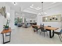 Open concept dining room with modern wood table and chandelier at 1329 Tullamore Blvd, Ormond Beach, FL 32174