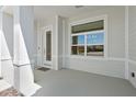 Covered porch entry with white door and window at 1329 Tullamore Blvd, Ormond Beach, FL 32174