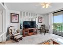 Living room with TV, comfy chair, and dining area at 1433 N Atlantic Ave # 422, Daytona Beach, FL 32118
