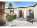 Inviting entryway with a rocking chair and Spanish-style architecture at 3120 John Anderson Dr, Ormond Beach, FL 32176