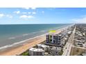 Aerial view of oceanfront building, highlighting its location at 1239 Ocean Shore Blvd # 7E5, Ormond Beach, FL 32176