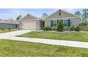 One-story home with neutral siding and a two-car garage at 225 Sunset Point Dr, Ormond Beach, FL 32174