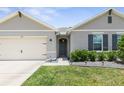 One-story home with a neutral facade and landscaping at 225 Sunset Point Dr, Ormond Beach, FL 32174