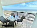 Spacious balcony with table and chairs, showcasing stunning ocean views at 2615 S Atlantic Ave # 7H, Daytona Beach, FL 32118