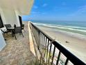 Spacious balcony with table and chairs, showcasing stunning ocean views at 2615 S Atlantic Ave # 7H, Daytona Beach, FL 32118