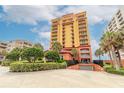 Luxury beachfront condo building with parking garage and tropical landscaping at 2901 S Atlantic Ave # 501, Daytona Beach, FL 32118