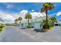 Row of garages with teal accents and palm trees at 2850 Ocean Shore Blvd # 15C, Ormond Beach, FL 32176