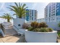 White staircase with landscaping and building view at 935 N Halifax Ave # 907, Daytona Beach, FL 32118