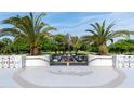 Landscaped entrance to community with palm trees at 935 N Halifax Ave # 907, Daytona Beach, FL 32118
