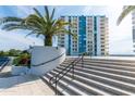 White staircase with landscaping and building view at 935 N Halifax Ave # 907, Daytona Beach, FL 32118
