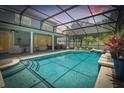 Relaxing screened pool and spa with patio furniture at 28 Dormer Dr, Ormond Beach, FL 32174