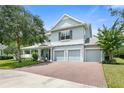 Two-story house with a brick driveway at 28 Dormer Dr, Ormond Beach, FL 32174