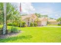 One-story house with palm trees, lush lawn and American flag at 415 Seabrook Rd, Ormond Beach, FL 32174