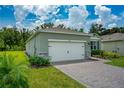 Single-story home with a two-car garage and landscaped front yard at 1743 Red Rock Rd, New Smyrna Beach, FL 32168