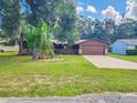 Ranch-style home with a spacious yard and driveway at 1119 Indigo Rd, Ormond Beach, FL 32174