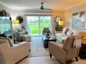 Bright living room with comfy seating, large TV, and sliding glass doors leading to a patio at 64 Ocean Palm S Dr # 64, Flagler Beach, FL 32136
