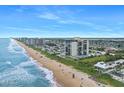 Aerial view of beachfront property and surrounding area at 1513 Ocean Shore Blvd # 6C, Ormond Beach, FL 32176