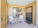 Welcoming entryway with two chairs and a doormat at 2600 Ocean Shore Blvd # 3060, Ormond Beach, FL 32176