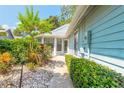 Pathway to the entrance of light blue house with landscaping at 985 Belleflower Dr, Port Orange, FL 32127