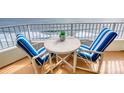 Ocean view balcony with small table and chairs, perfect for relaxing at 2937 S Atlantic Ave # 1504, Daytona Beach, FL 32118