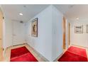 Bright and airy entryway with red runner rugs and tasteful wall art at 2545 S Atlantic Ave # 1701, Daytona Beach Shores, FL 32118