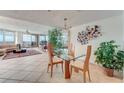 Open concept dining area with glass table, offering views to the living room at 2545 S Atlantic Ave # 1701, Daytona Beach Shores, FL 32118