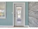 White door with glass panel and wood accent wall at 2110 N Oleander Ave, Daytona Beach, FL 32118